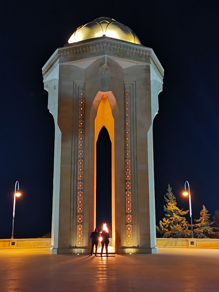 Eternal Flame memorial lit at night on Martyrs' Lane